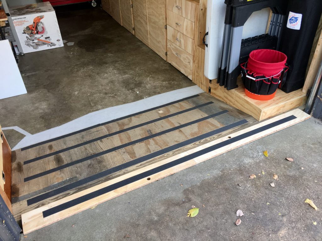 Here is the ramp bride that covers the opening where the garage door closes. I put this down when I will be working with the door open for a while. The edges have a 45 degree taper to make it easier for stuff to roll over. Grip tape added because just a light layer of saw dust can be very slipper, not to mention water.